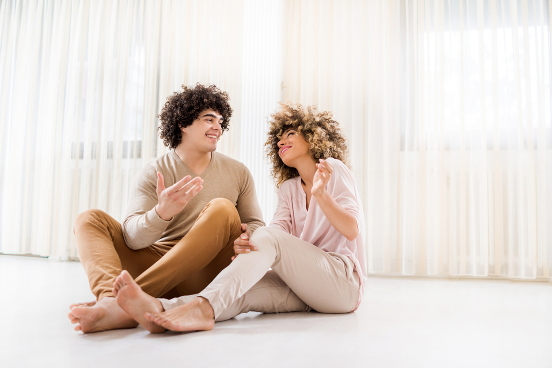 a couple laughing after having effective communication with one another
