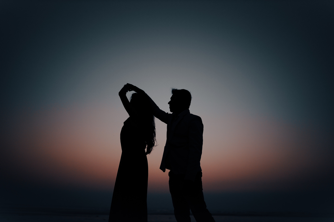 silhouette of a dancing couple at sunset